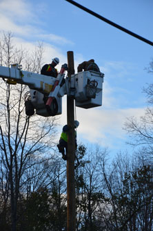 Linemen repairing pole